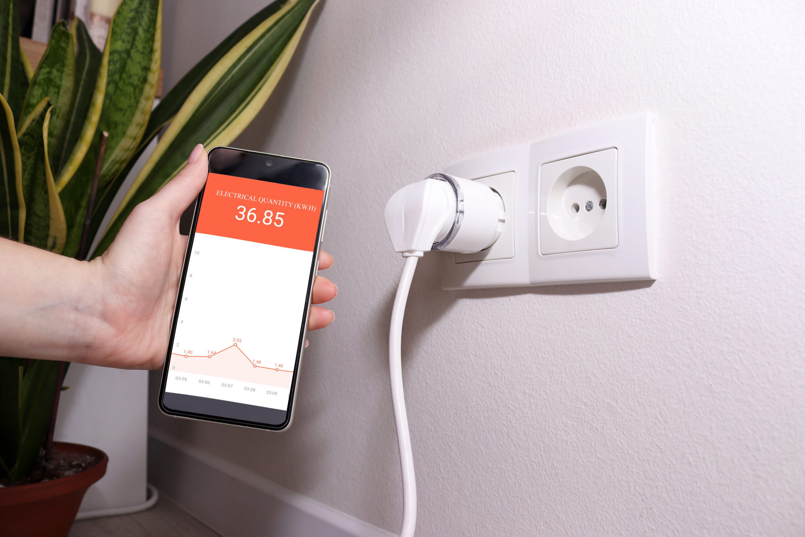 Smart plug with energy monitoring app displaying power consumption statistics.